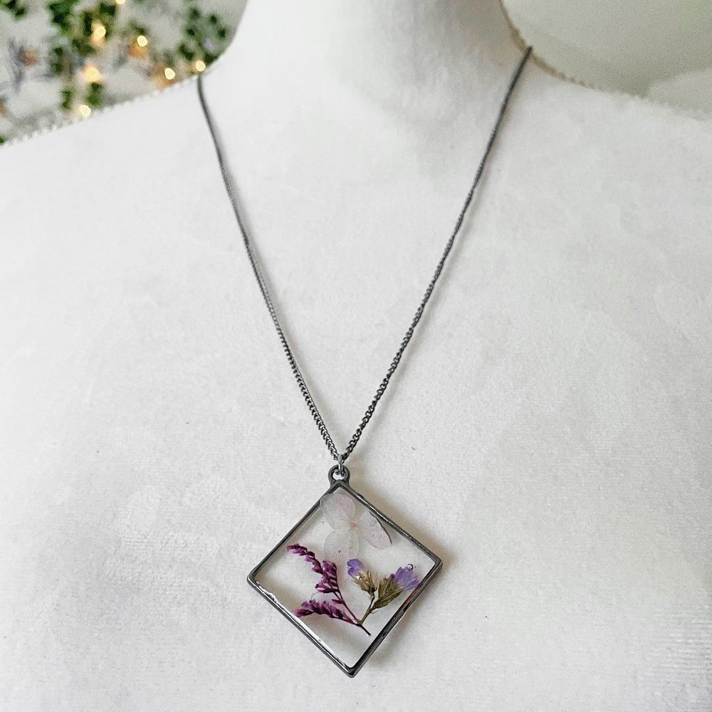 Purple and white floral botanical resin necklace with dark silver bezel